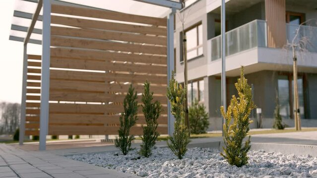 Backyard of modern new built cube 2 level home, with wooden outside pation. Housing area, property, architecture.