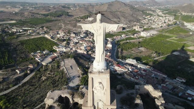 Aerial orbiting around Christ statue of Monteagudo castle at Murcia in Spain