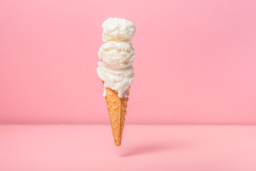 funny creative concept of hovering in air wafer cone with ice cream on pink background