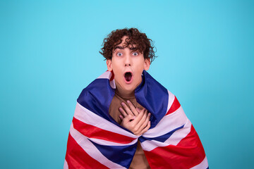 Young attractive guy with a flag posing in the studio.