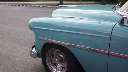 Green retro car on the road close-up, Cuba, Havana