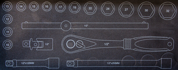 Image of a set of wrenches on a black surface.