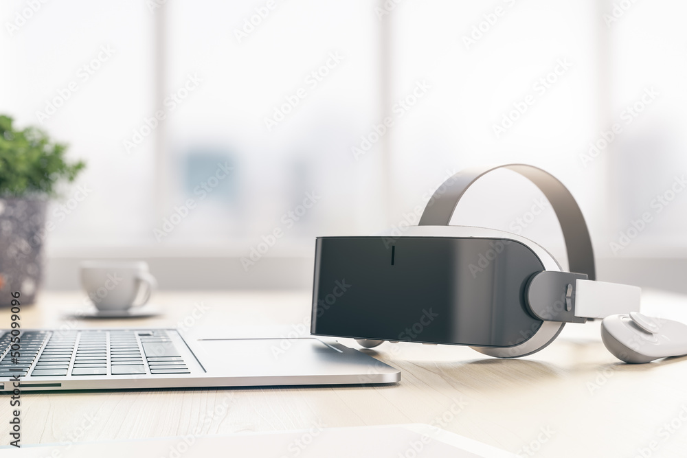 Poster virtual reality and metaverse concept with modern vr helmet, joystick and laptop on wooden table. 3d