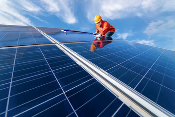 Man is working on cleaning solar panels. repair, maintenance, reuse, and periodical maintenance of solar panels, green power clean energy Earth conservation, and environment concept