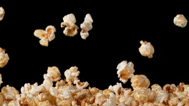 Super Slow Motion of Popcorn Flying on Black Background.