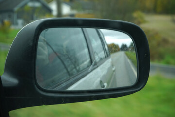 Side rear-view mirror on a car.