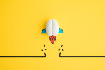 Brain rocket breaking through black wall obstacle on yellow background minimal style. Concept of...
