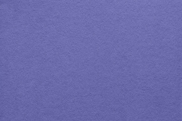 Texture of old navy blue paper background, macro. Very peri color of the year 2022.