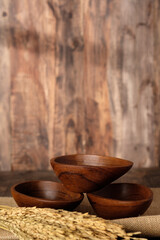 empty wood bowl with rice on wood table.mockup for product