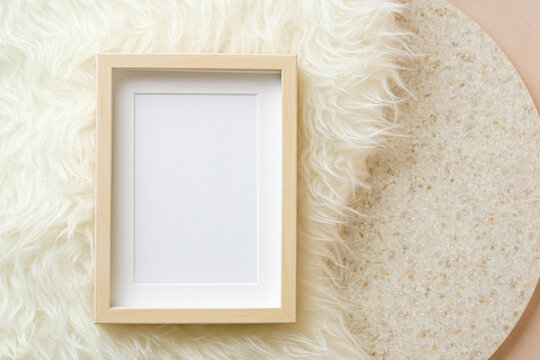 blank photo frame on white fur and marble stand background
