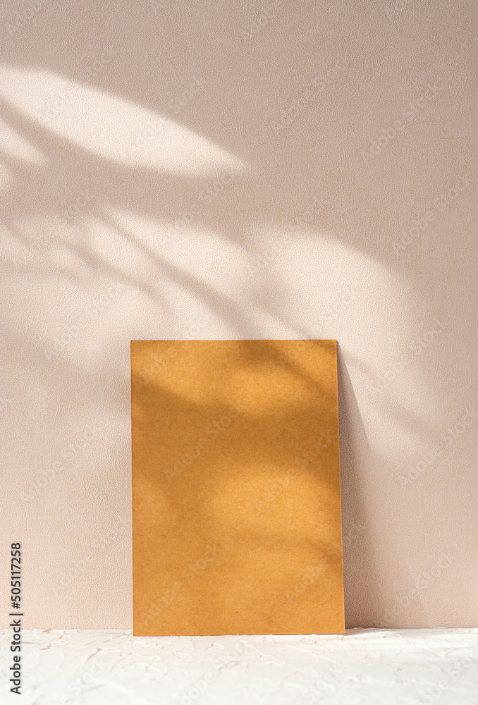 Wall mural blank kraft paper poster with pampass grass in wood vase on cement table at peach wall