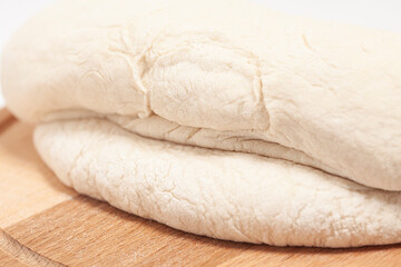 Fototapeta na wymiar Fresh yeast dough on cutting board