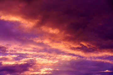 Colorful sunset in the evening sky. Clouds illuminated by the setting sun. Amazing sky panorama. Meditative calmness and greatness. Mystical lighting. Great dramatic view