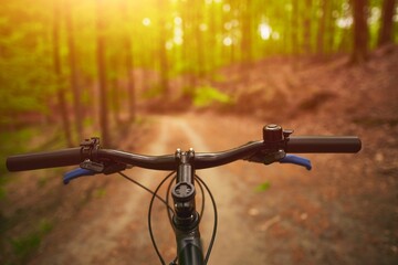 First person view of bicycle handlebar with strong sunlight