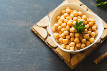 Cooked chickpeas in white bowl. Ingredient for Tasty vegetarian food. Boiled chickpeas, selective focus