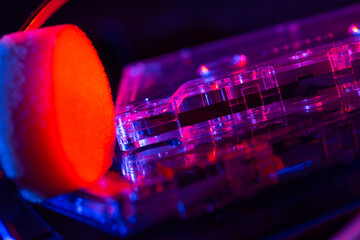 Vintage cassette tape player in neon light. 80s - 90s advertisement style. Disco party nostalgy...