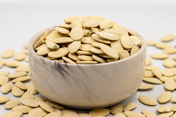 Shelled pumpkin seeds on a white background. Close-up. local name kabak cekirdegi