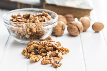 Peeled walnut kernels on white table.