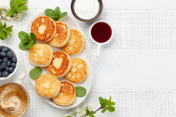 Cottage pancakes with jam, sour cream and berries