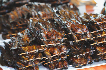 Fototapeta Sun-dried catfish skewers stacked on top of food stalls. Thai traditional food. obraz
