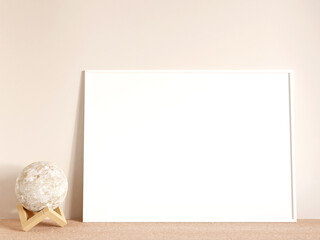 Fototapeta na wymiar Modern and minimalist horizontal white poster or photo frame mockup on the living room wooden table. 3d rendering.