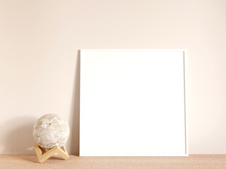 Modern and minimalist square white poster or photo frame mockup on the living room wooden table. 3d rendering.