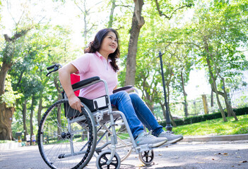 Image of middle-age Asian woman sitting on wheelchair