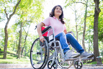 Naklejka premium Image of middle-age Asian woman sitting on wheelchair
