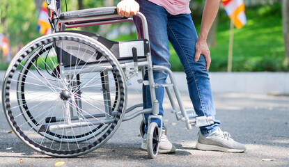 Naklejka premium Image of middle-age Asian woman sitting on wheelchair