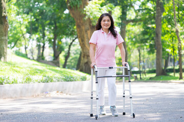 Image of middle age Asian woman practicing walking in the park