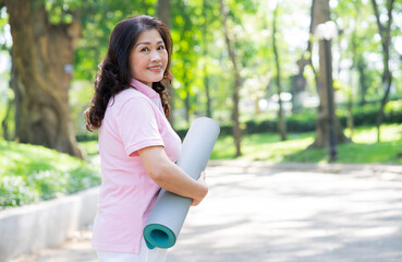 Image of middle age Asian woman exercise at park