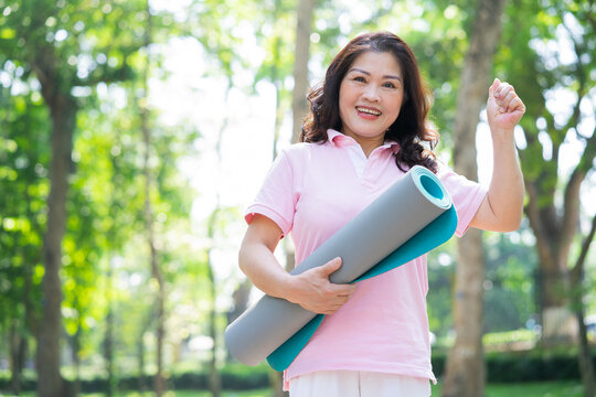 Image of middle age Asian woman exercise at park