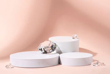 White podium with diamonds on a pink background.