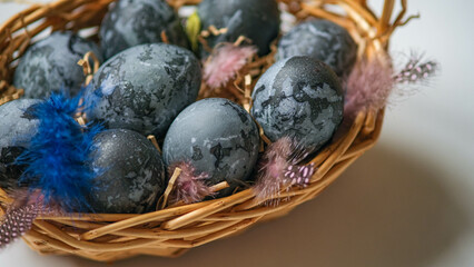 Easter card with a copy of the place for the text. Purple, blue eggs in a basket on a white background. Natural dye karkade tea.