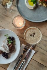 Still life shot of coffee cocktail and delicious desserts on a table in a cafe.
