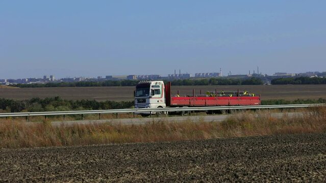 The truck transports metal. Truck with matal rides on the highway