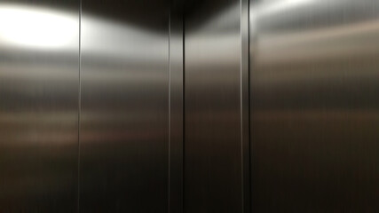 Inside passenger elevator,Reflection of light on a shiny metal texture,stainless steel background.