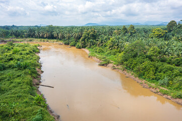 Muddy brown jungle stream meanders through the untouched Rain forest at Bentong, Pahang, Malaysia. Aerial view of a river in the Krau Wildlife Reserve. Habitat for wild animals and endangered animal