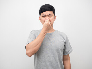 Man feeling smelly close his nose portrait white background