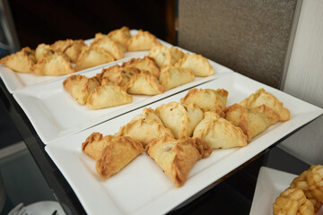 Triangular pies on a plate uchpochmak catering. © Евгений Вершинин