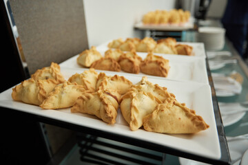 Triangular pies on a plate uchpochmak catering. © Евгений Вершинин