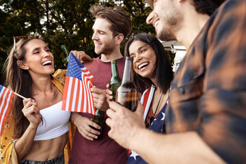 Group of young friends celebrating 4th of July on the camping