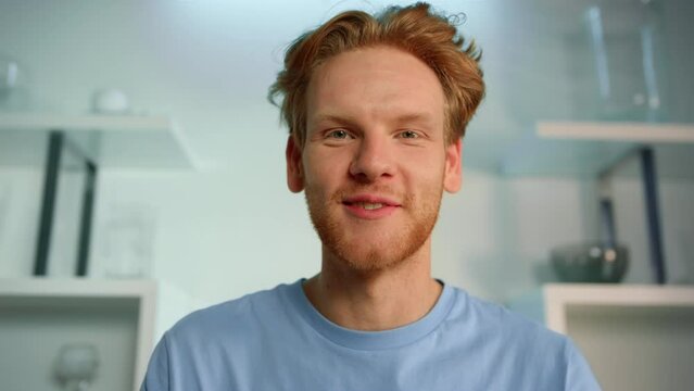 Closeup freelancer talk interview at home office. Smiling ginger man video call