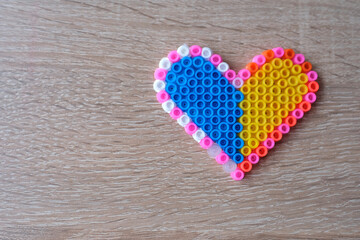 close-up of blue yellow heart, creating perler bead patterns, make flag of ukraine using...