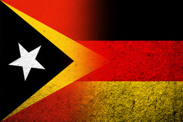 The national flag of Germany with East Timor National flag. Grunge background