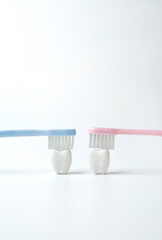 Fototapeta na wymiar Blue and Pink toothbrush on smile confident tooth on white background , blue like a boy and pink like a girl 