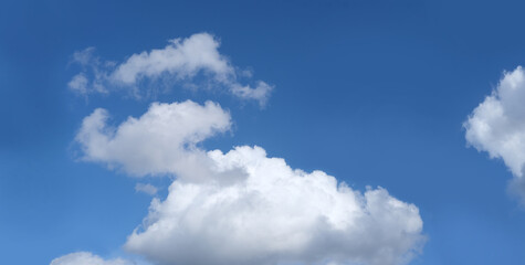 dramatic background light sky gradient, close-up of beautiful white fluffy clouds in blue sky, concept of lightness, elevation, heavenly space, the abode of God, natural basis for the designer