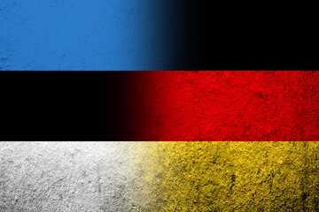 The national flag of Germany with The Republic of Estonia national flag. Grunge background