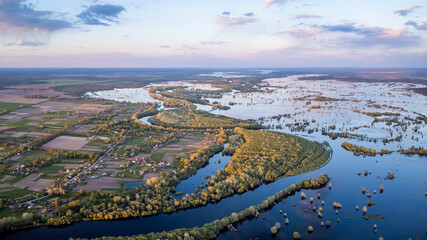 Picturesque aerial landscape of village near flooded valley of river Desna at sunset. Countryside...