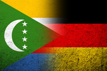 The national flag of Germany with The Union of the Comoros National flag. Grunge background